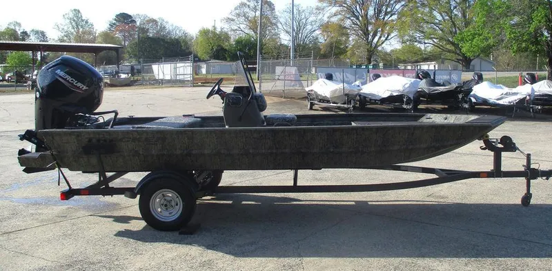 Slide: The Image of 2025 Tracker GRIZZLY® 1860 CC boat on trailer, parked outdoors. - 3