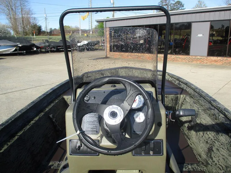 Slide: The Image of 2025 Tracker GRIZZLY® 1860 CC boat console with steering wheel and gauges. - 4