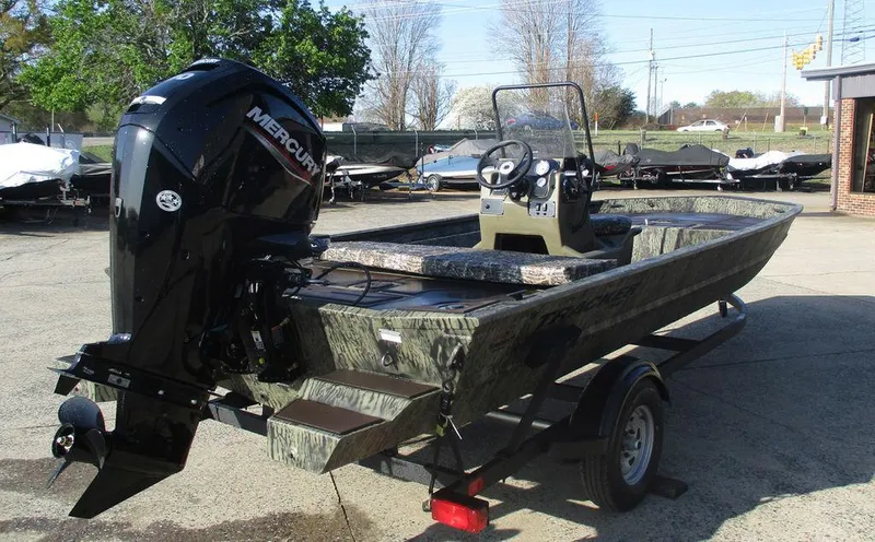 Slide: The Image of 2025 Tracker GRIZZLY® 1860 CC boat with Mercury engine on a trailer. - 5
