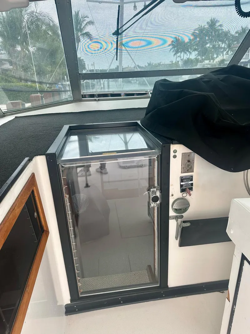 Slide: The Image of 1974 Bertram 42 Motor Yacht interior with control panel and storage compartment. - 18