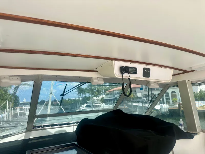 Slide: The Image of Interior view of a 1974 Bertram 42 Motor Yacht, showcasing the helm area and windows. - 20