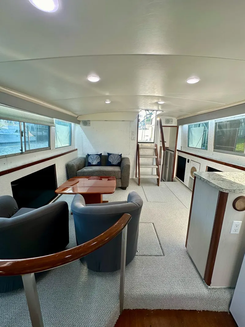Slide: The Image of Interior of a 1974 Bertram 42 Motor Yacht with modern seating and ample natural light. - 22