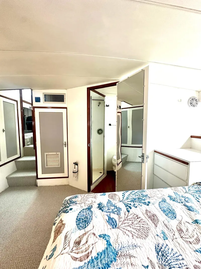 Slide: The Image of 1974 Bertram 42 Motor Yacht interior with bed, shower, and storage cabinets. - 24