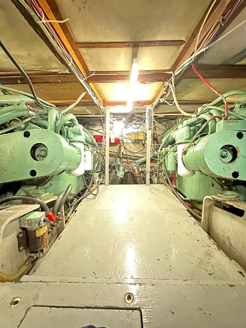 Slide: The Image of Engine room of a 1974 Bertram 42 Motor Yacht with visible machinery and wiring. - 33