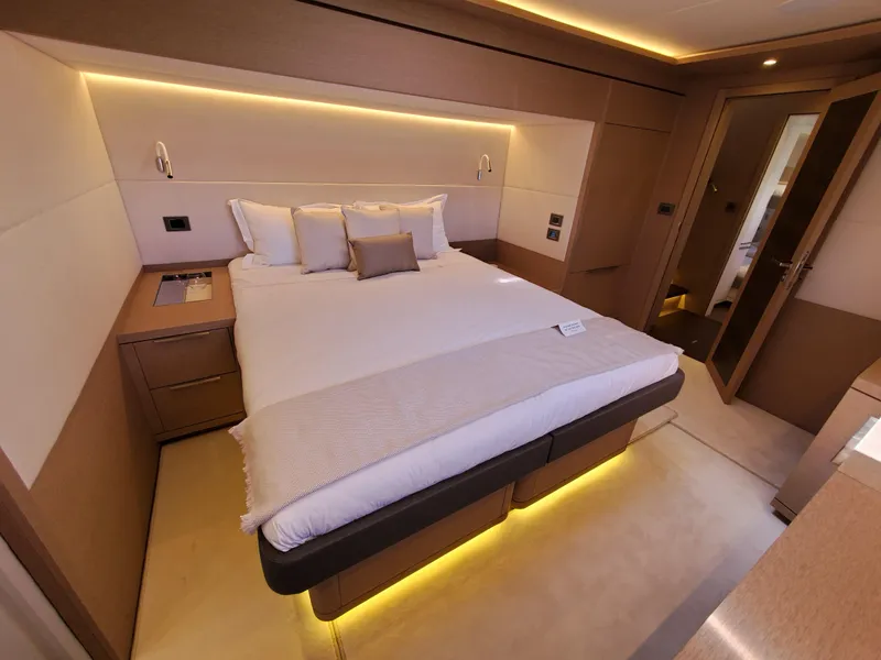 Slide: The Image of Luxurious bedroom interior of 2020 Lagoon SEVENTY 7 yacht with modern lighting and elegant design. - 10