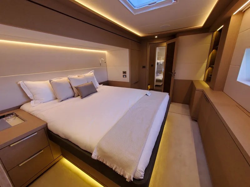 Slide: The Image of Luxurious bedroom interior of 2020 Lagoon SEVENTY 7 yacht with modern lighting and elegant design. - 13