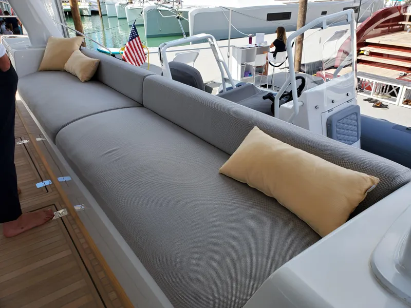 Slide: The Image of Luxurious seating area on 2020 Lagoon SEVENTY 7 yacht with cushions and marina view. - 16