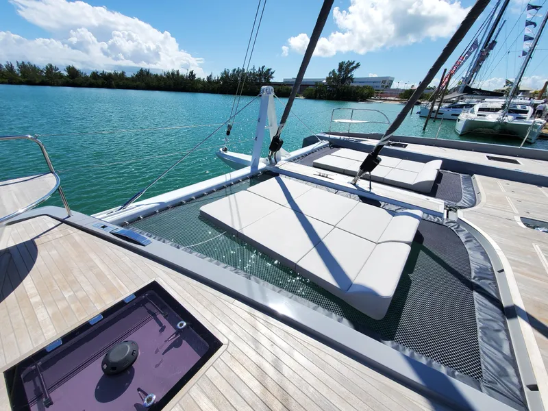 Slide: The Image of Luxurious 2020 Lagoon SEVENTY 7 yacht with sunbathing area on turquoise water. - 20