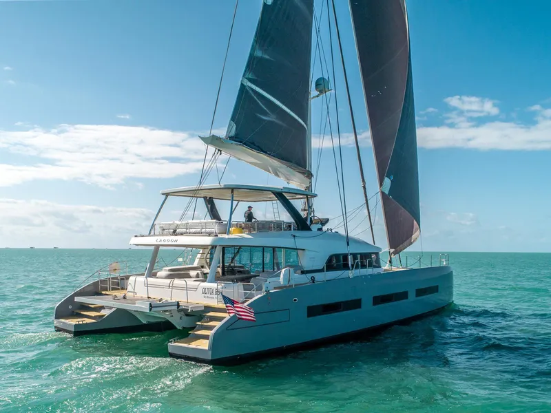 Slide: The Image of 2020 Lagoon SEVENTY 7 catamaran sailing on clear blue ocean waters. - 26