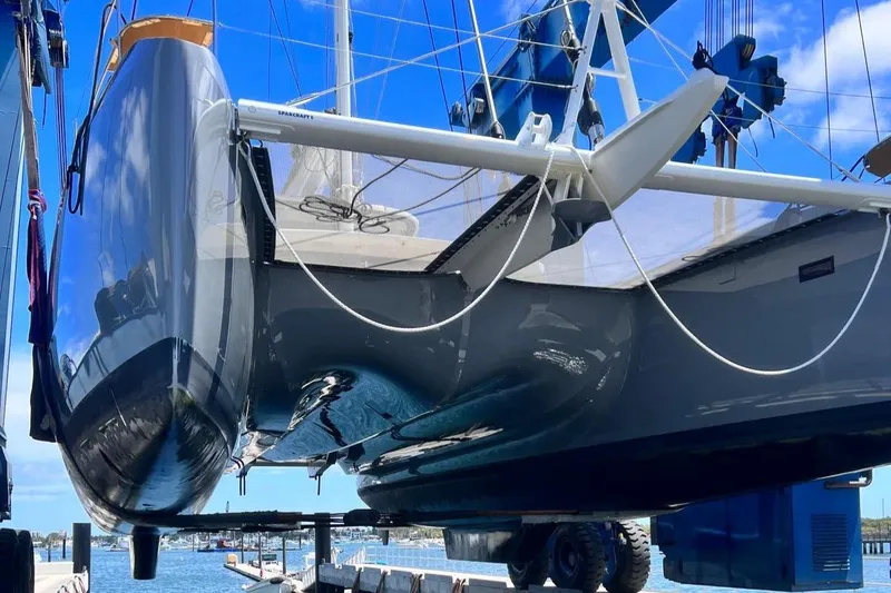 Slide: The Image of 2020 Lagoon SEVENTY 7 yacht in dry dock, showcasing sleek hull design and modern features. - 42