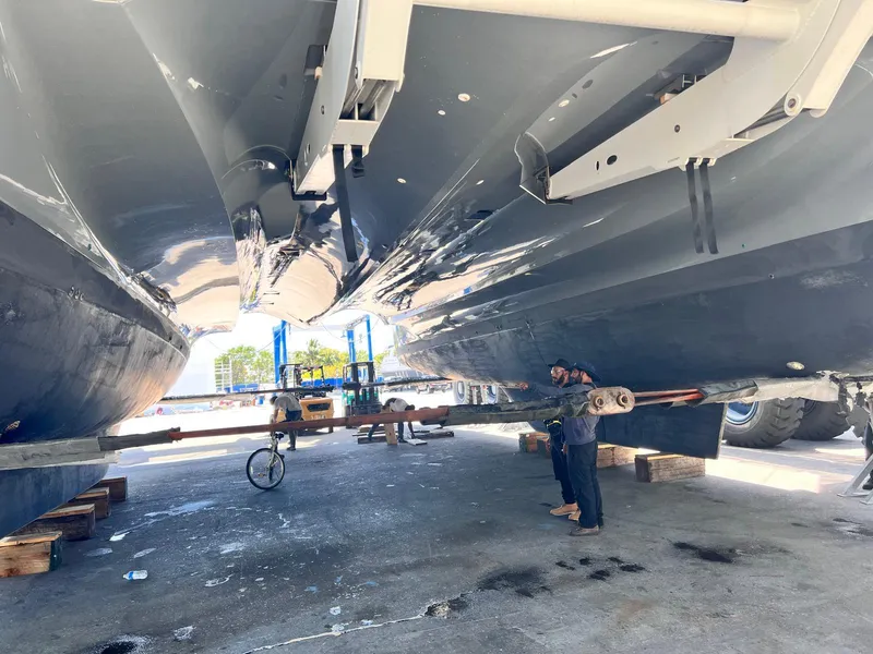 Slide: The Image of 2020 Lagoon SEVENTY 7 catamaran under maintenance, showcasing its sleek hull design. - 44