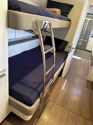 Slide: The Image of Bunk beds with blue bedding in a 2020 Lagoon SEVENTY 7 yacht interior. - 47