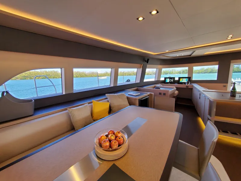 Slide: The Image of Luxurious interior of 2020 Lagoon SEVENTY 7 yacht with panoramic windows and modern decor. - 7