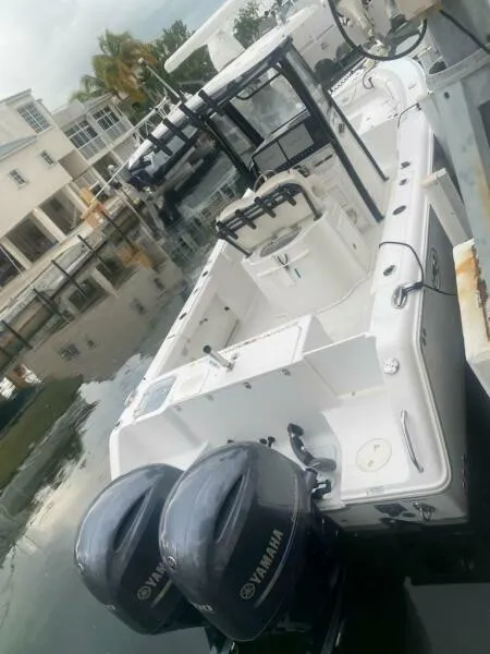 Slide: The Image of 2018 Sea Hunt Gamefish 27 boat docked with dual Yamaha engines. - 13