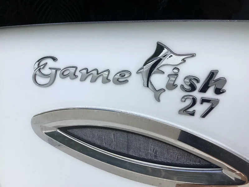 Slide: The Image of Sea Hunt Gamefish 27 logo on 2018 model boat, featuring sleek design elements. - 17