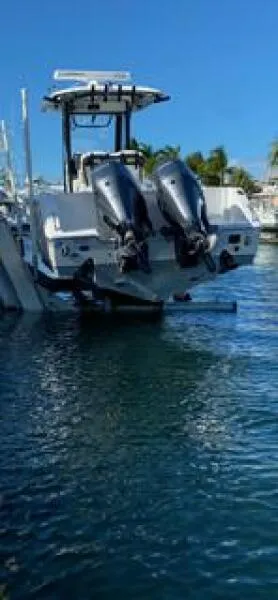 Slide: The Image of 2018 Sea Hunt Gamefish 27 with dual outboard motors on water. - 21