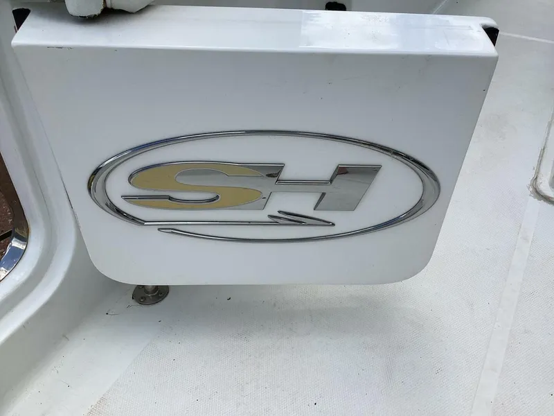 Slide: The Image of 2018 Sea Hunt Gamefish 27 logo on white boat surface. - 22