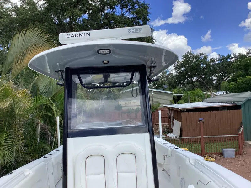 Slide: The Image of 2018 Sea Hunt Gamefish 27 boat with Garmin xHD2 radar, surrounded by lush greenery. - 25
