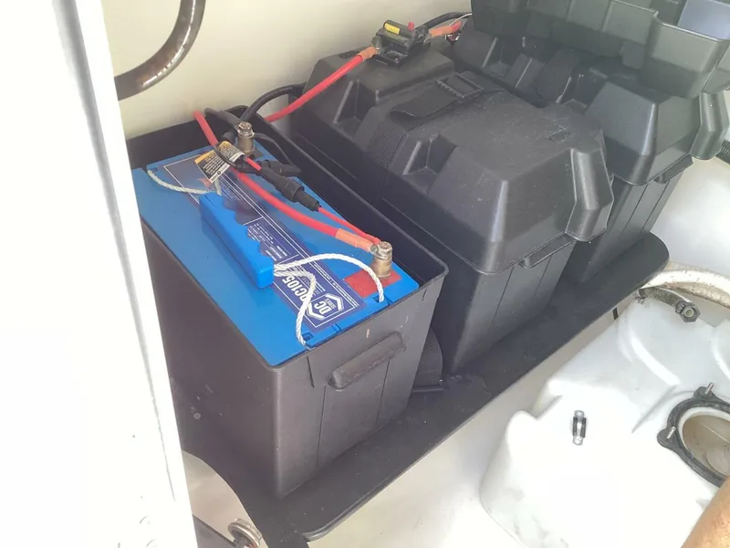 Slide: The Image of Battery compartment of a 2018 Sea Hunt Gamefish 27 boat, featuring a blue marine battery. - 37