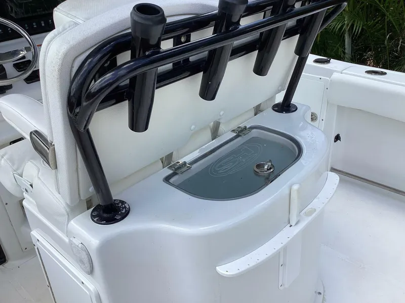 Slide: The Image of 2018 Sea Hunt Gamefish 27 boat interior with rod holders and storage compartment. - 43