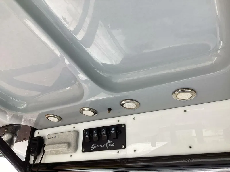 Slide: The Image of 2018 Sea Hunt Gamefish 27 boat console with controls and lighting. - 44