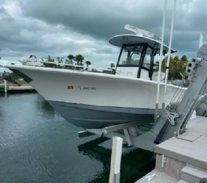 Slide: The Image of 2018 Sea Hunt Gamefish 27 boat docked at marina under cloudy skies. - 5