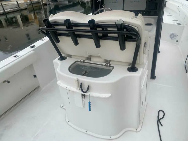 Slide: The Image of 2018 Sea Hunt Gamefish 27 boat interior with rod holders and storage compartment. - 9