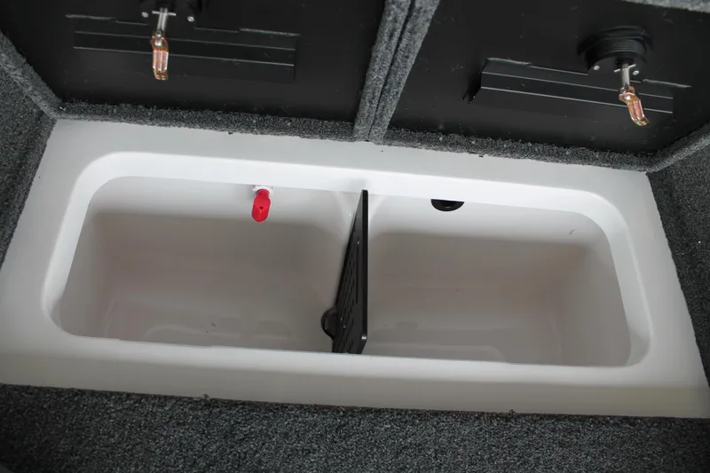 Slide: The Image of 2025 Vexus AVX2080 boat storage compartment with divider and carpeted interior. - 22