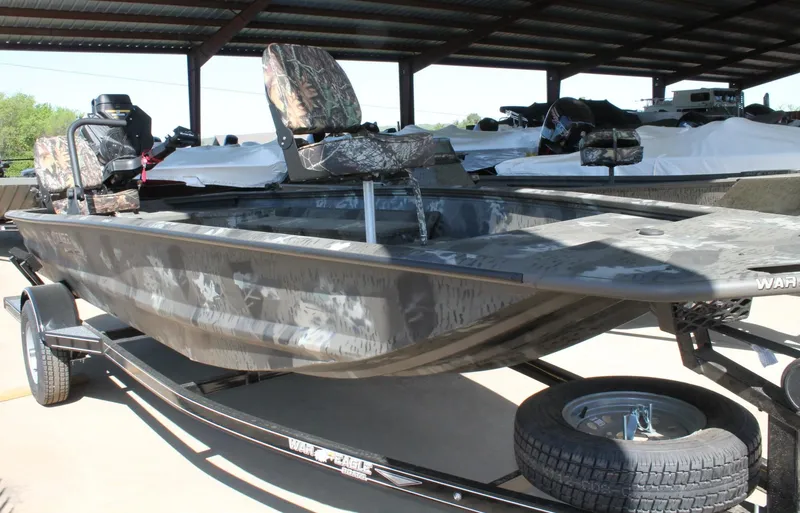 Slide: The Image of 2025 War Eagle 750 Gladiator boat with camouflage seats on a trailer. - 10