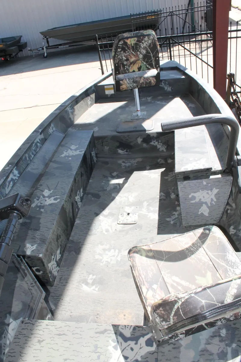 Slide: The Image of 2025 War Eagle 750 Gladiator boat interior with camouflage seating and flooring. - 15