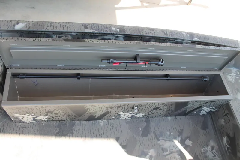Slide: The Image of Open storage compartment in 2025 War Eagle 750 Gladiator boat, featuring camouflage design. - 17