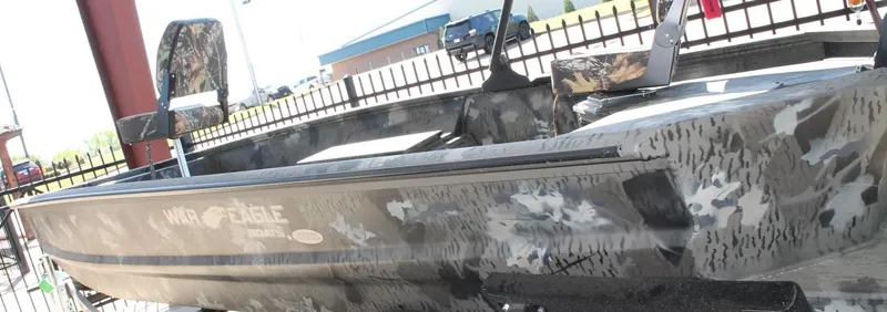 Slide: The Image of 2025 War Eagle 750 Gladiator boat with camouflage design, displayed outdoors. - 3