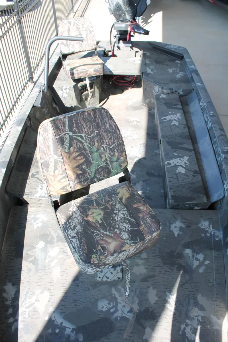 Slide: The Image of 2025 War Eagle 750 Gladiator boat interior with camouflage seating and spacious layout. - 5