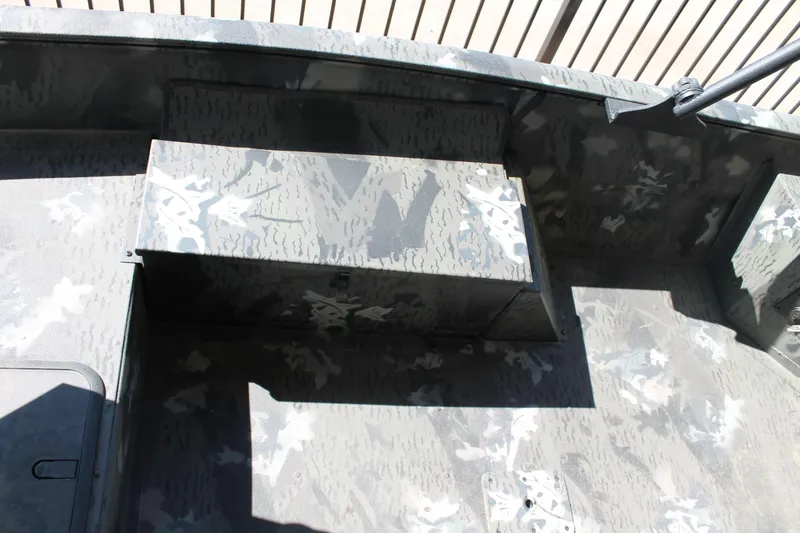 Slide: The Image of 2025 War Eagle 750 Gladiator boat interior with camouflage pattern and storage compartment. - 6