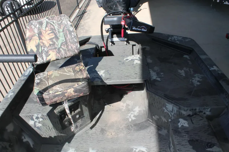 Slide: The Image of 2025 War Eagle 750 Gladiator boat interior with camouflage seating and GatorTail motor. - 7