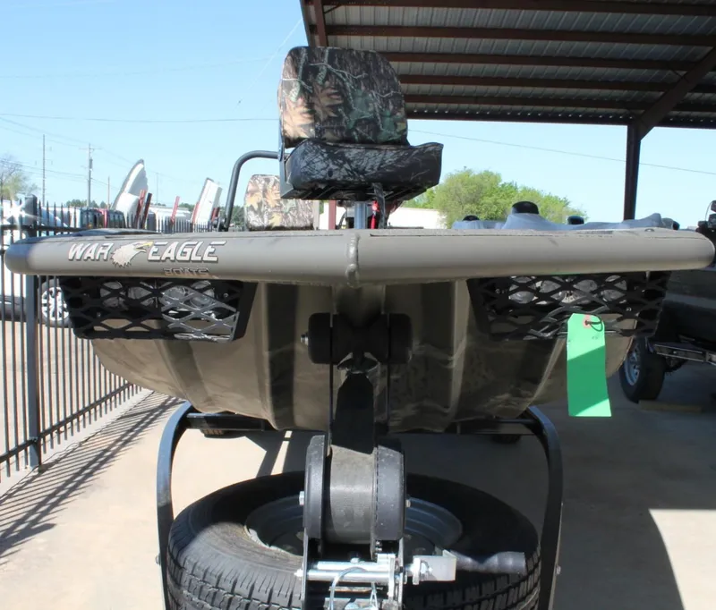 Slide: The Image of 2025 War Eagle 750 Gladiator boat with camouflage seat, displayed on a trailer. - 9
