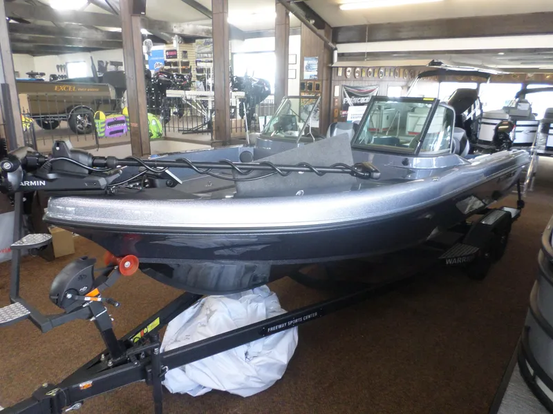 Slide: The Image of 2025 Warrior 238 DC boat displayed indoors, featuring sleek design and modern equipment. - 1