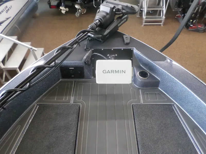 Slide: The Image of 2025 Warrior 238 DC boat with Garmin navigation system on deck. - 11