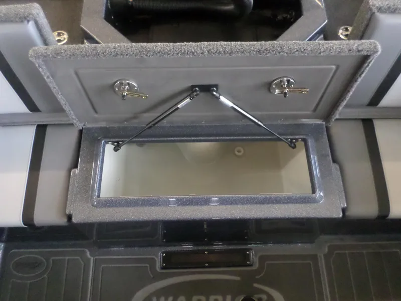Slide: The Image of 2025 Warrior 238 DC boat storage compartment with open lid and hydraulic support. - 14