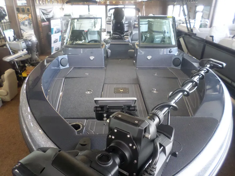 Slide: The Image of 2025 Warrior 238 DC boat interior with advanced navigation system and spacious deck. - 2