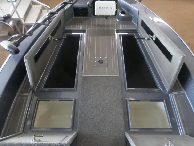 Slide: The Image of 2025 Warrior 238 DC boat interior with Garmin system and storage compartments. - 3