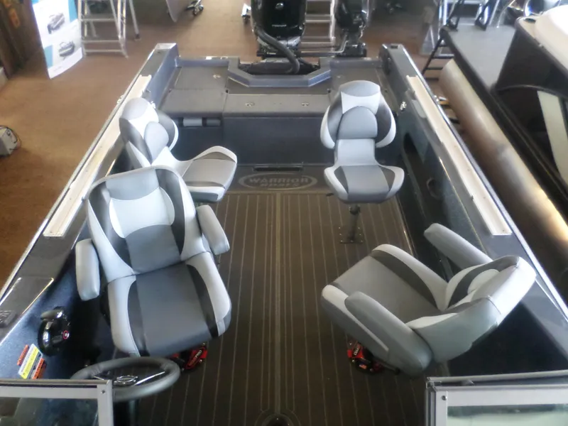 Slide: The Image of 2025 Warrior 238 DC boat interior with four modern seats and sleek design. - 5