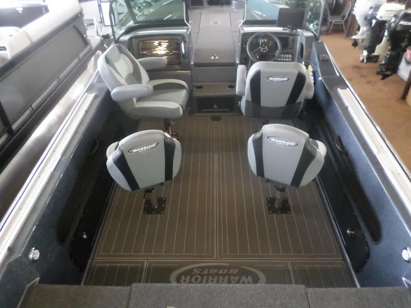 Slide: The Image of 2025 Warrior 238 DC boat interior with seating and steering console. - 6