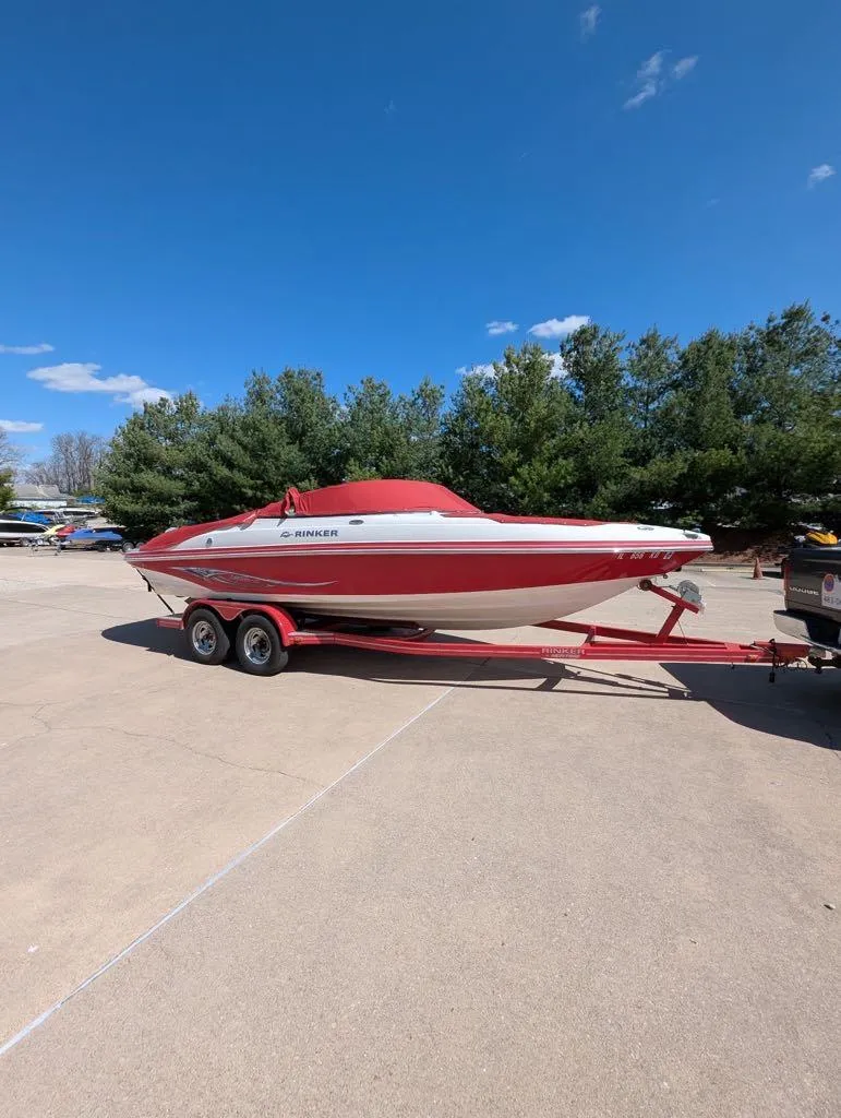 Slide: The Image of 2006 Rinker Captiva 226 boat on trailer, parked outdoors under clear blue sky. - 10