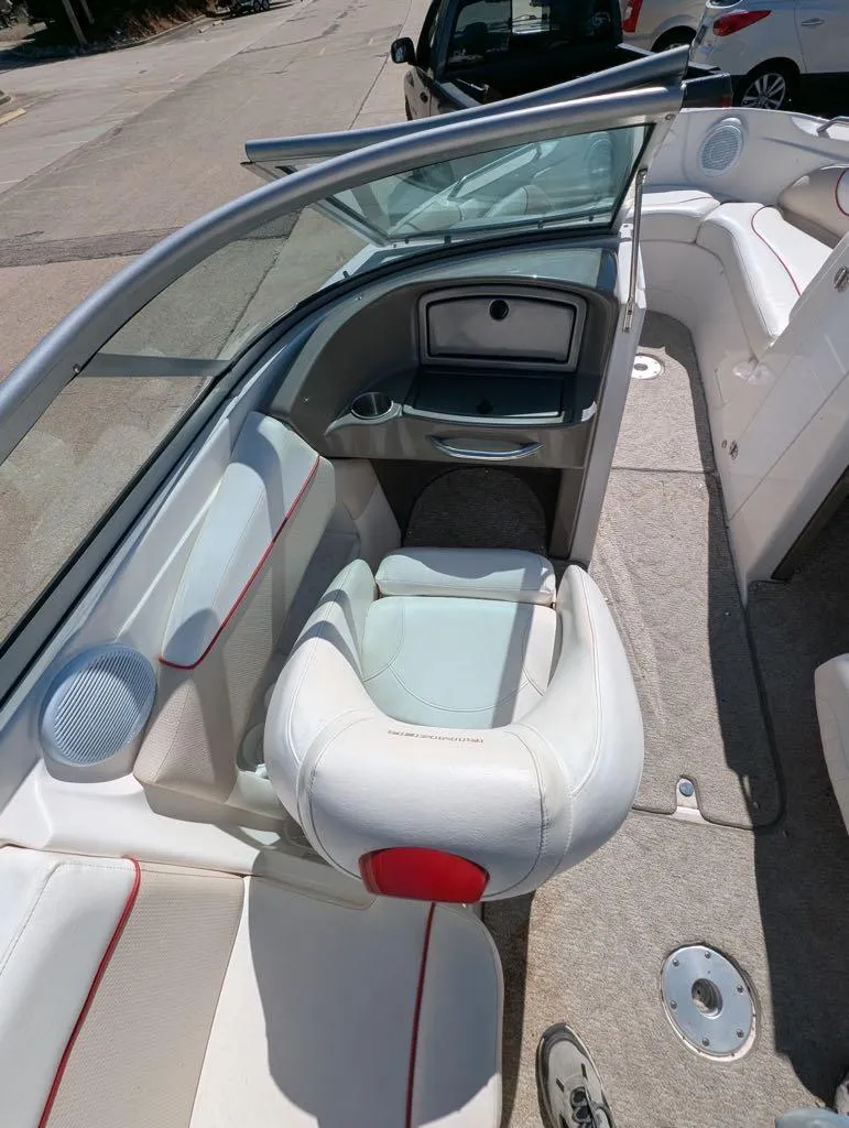 Slide: The Image of 2006 Rinker Captiva 226 boat interior with white seating and red accents. - 7