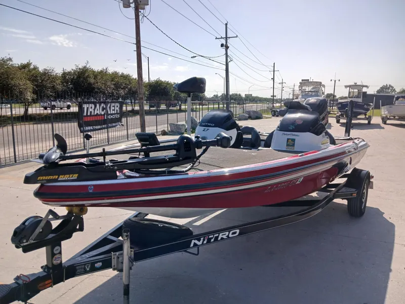 Slide: The Image of 2015 Nitro Z7 boat on trailer, parked outdoors, featuring Minn Kota trolling motor. - 11