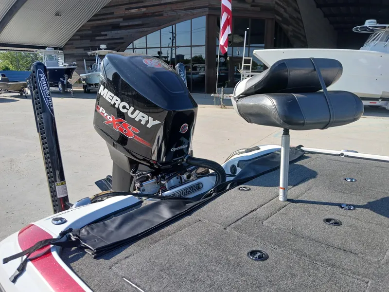 Slide: The Image of 2015 Nitro Z7 boat with Mercury Pro XS engine and Power-Pole, docked near other boats. - 13