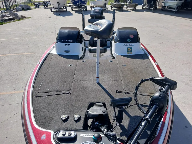 Slide: The Image of 2015 Nitro Z7 boat with fishing deck and motor, parked outdoors. - 4