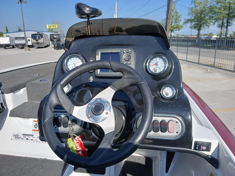 Slide: The Image of Steering console of a 2015 Nitro Z7 boat with gauges and controls. - 8