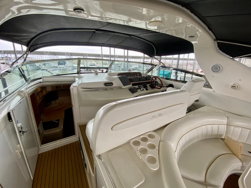 Slide: The Image of 1996 Sea Ray 450 Sundancer yacht interior with helm, seating, and cup holders. - 11